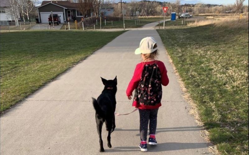 girl and dog on trail