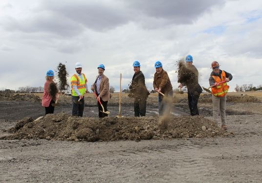 The team uses gold shovels to dig up dirt and celebrate the groundbreaking. 